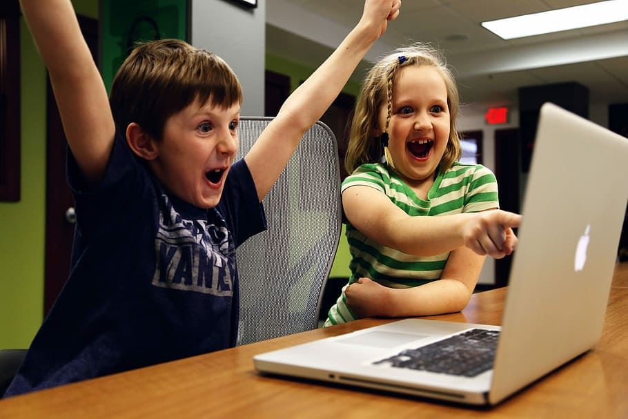 Boy excited using Chromebox at school