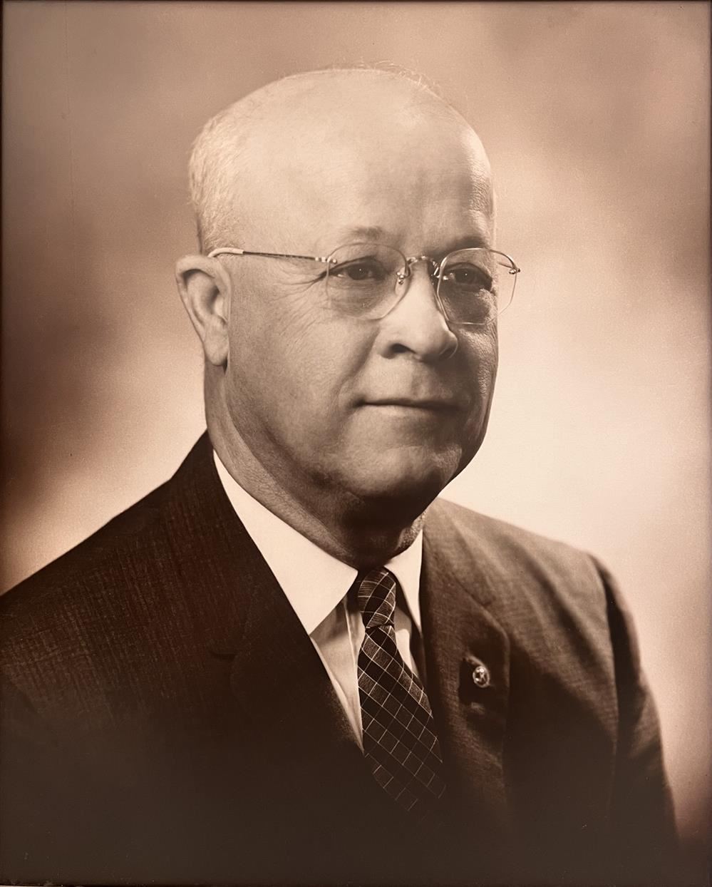 Picture of Clarence S. Porter wearing a black suit, white shirt, tie, wearing glasses. Picture of Clarence S. Porter wearing a black suit, white shirt, tie, wearing glasses.
